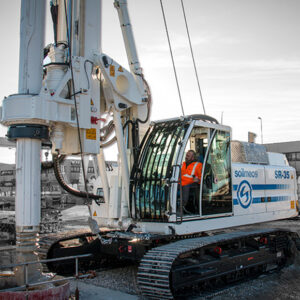 A backhoe parked on a construction site, ready for work.