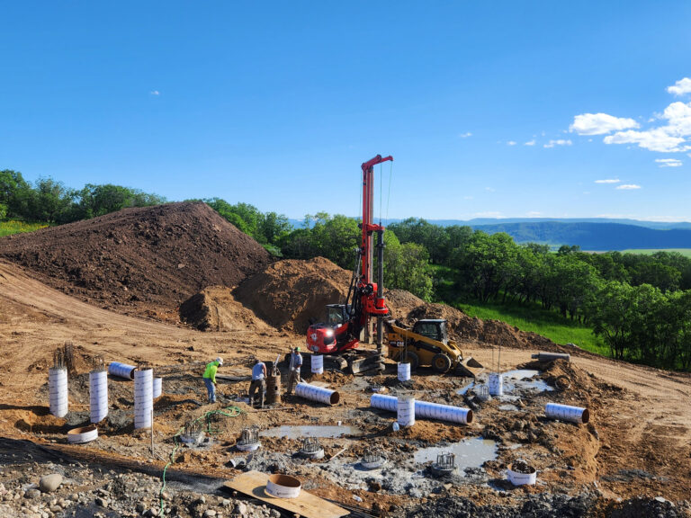 Construction of a new home nestled in the serene woods, blending harmoniously with nature's beauty.