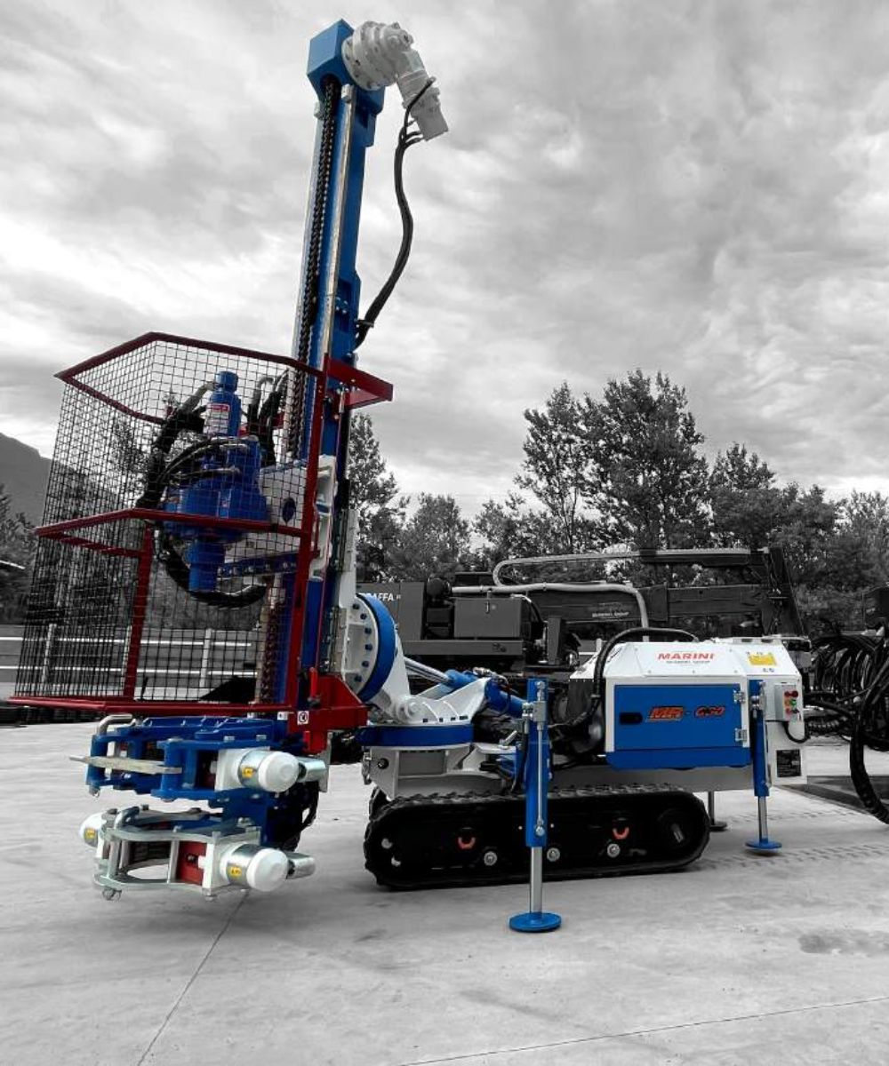A monochrome image of a drilling rig in action